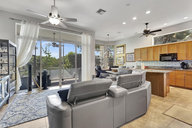 tiled living room featuring ceiling fan