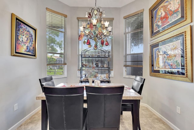 tiled dining room with a chandelier