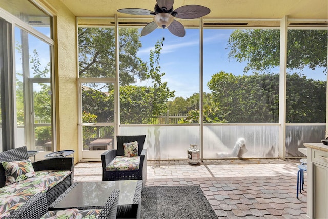 sunroom featuring a wealth of natural light and ceiling fan