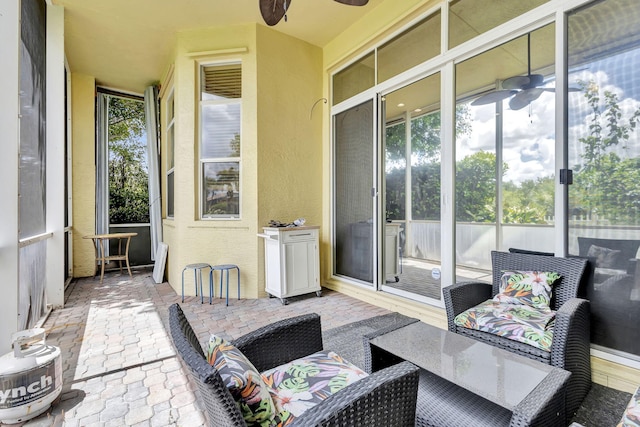 sunroom featuring ceiling fan