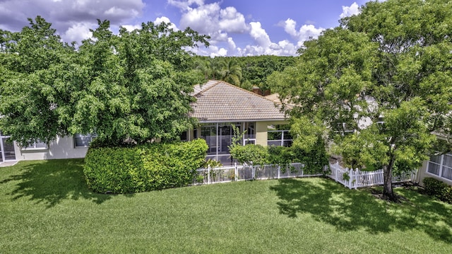 rear view of house featuring a lawn