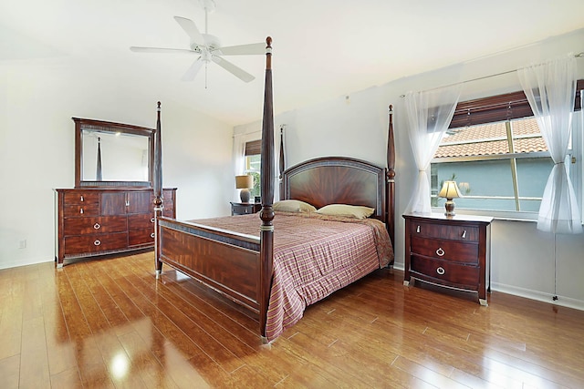 bedroom with ceiling fan, light wood-type flooring, and multiple windows