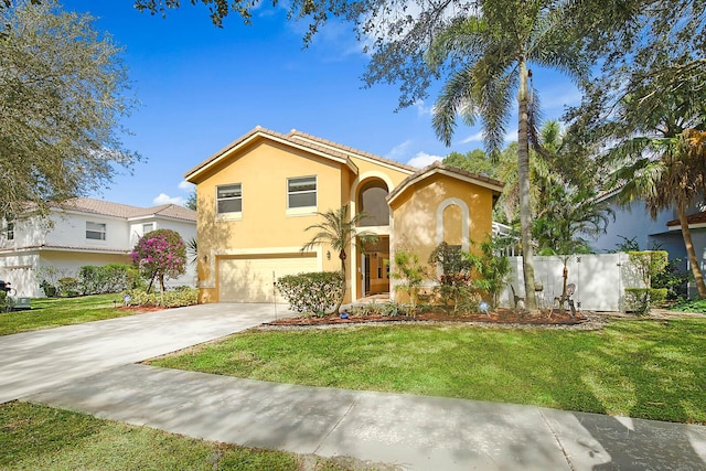 mediterranean / spanish home with a front yard and a garage