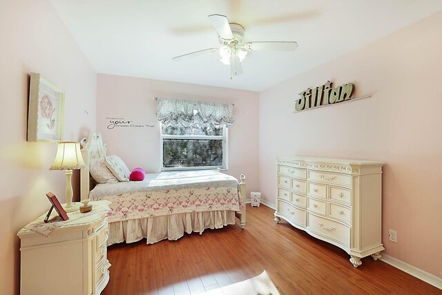 bedroom with hardwood / wood-style floors and ceiling fan