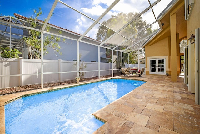 view of pool featuring a lanai, a patio area, and french doors