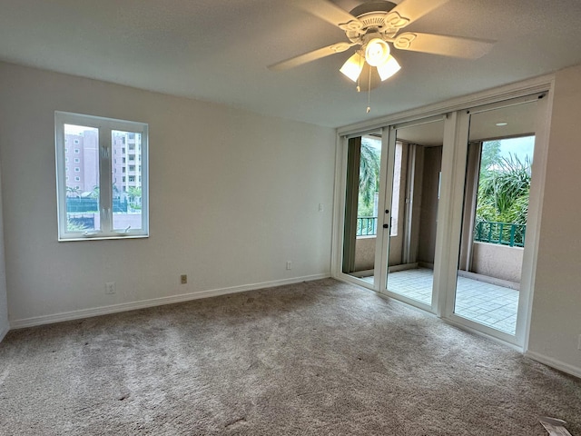 carpeted empty room with ceiling fan