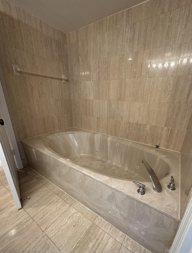 bathroom featuring tile patterned floors and a bath