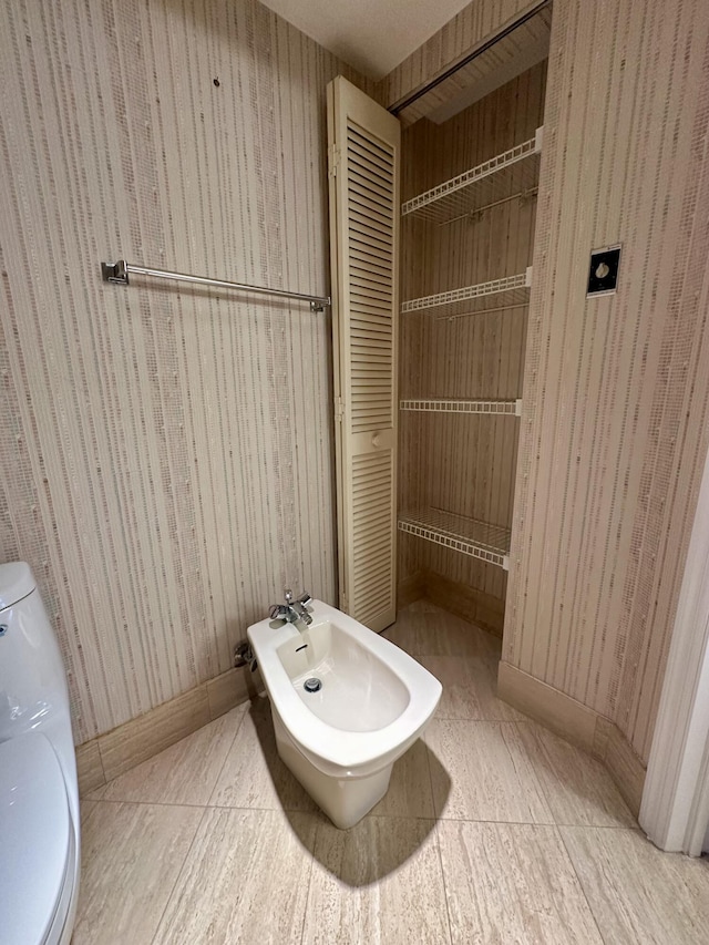 bathroom featuring a bidet and toilet