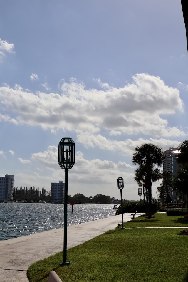 view of community featuring a lawn and a water view