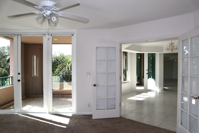 doorway with tile patterned floors, a wealth of natural light, french doors, and ceiling fan