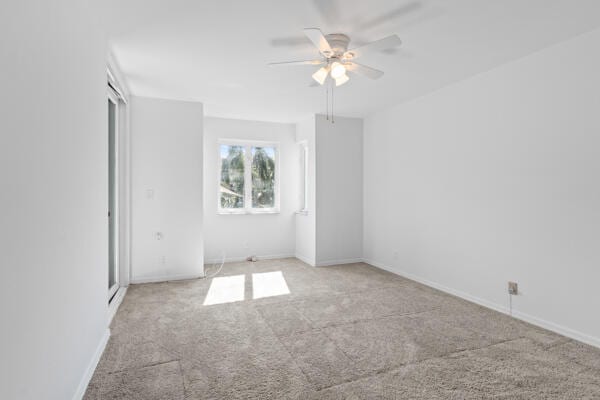 spare room featuring ceiling fan and light carpet