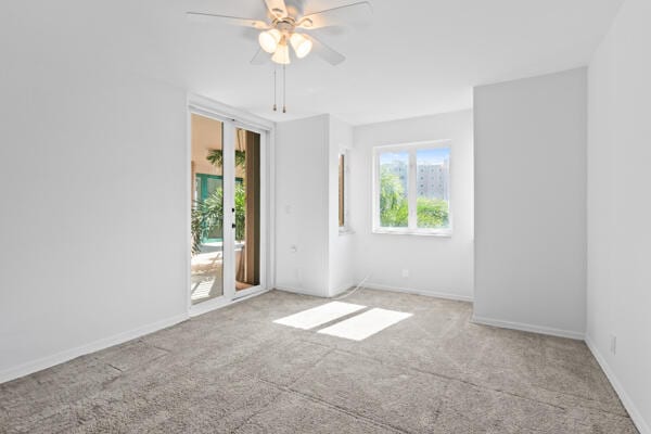 empty room with light colored carpet and ceiling fan