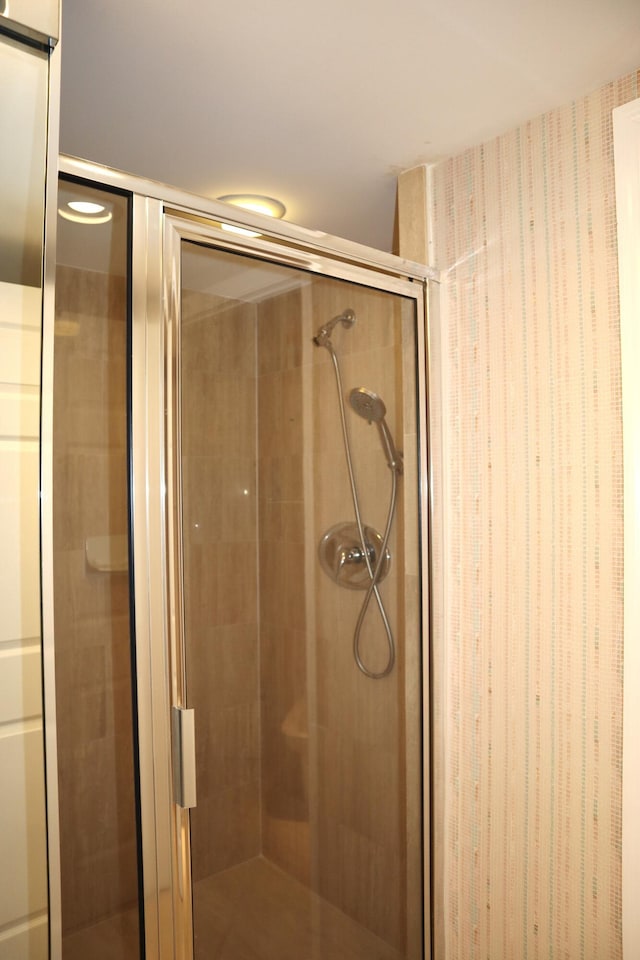 bathroom with a shower with door