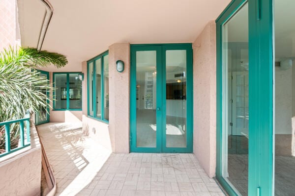 property entrance with french doors and a balcony