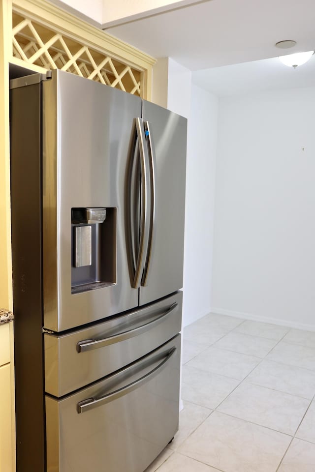 kitchen featuring stainless steel fridge and light tile patterned flooring