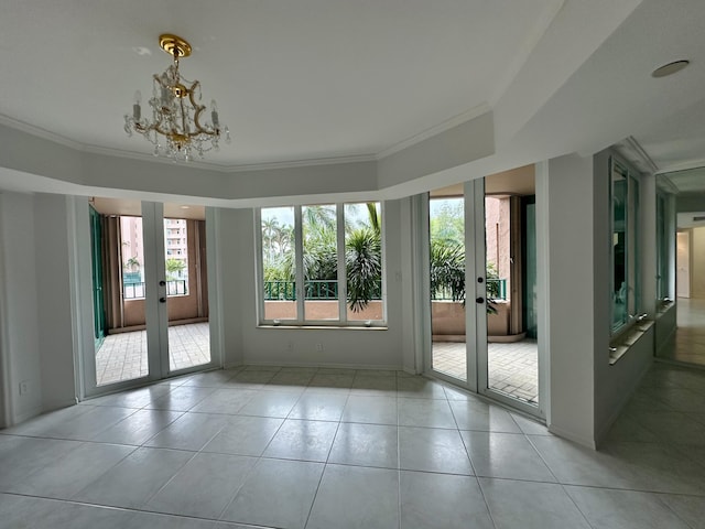 entryway with a chandelier, french doors, light tile patterned floors, and crown molding