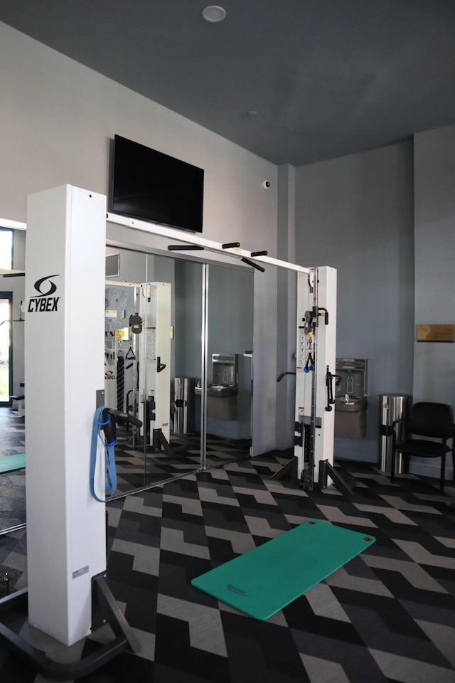 workout area with a high ceiling