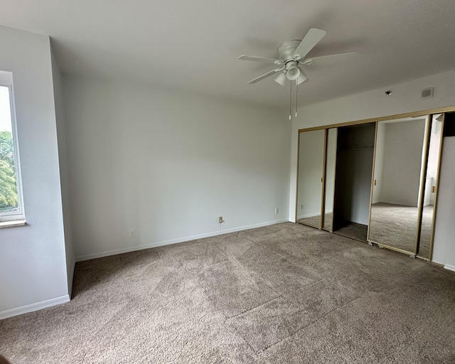 unfurnished bedroom with carpet flooring, ceiling fan, and a closet