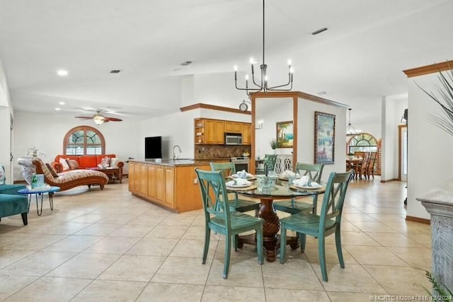 dining space featuring vaulted ceiling, light tile patterned flooring, and ceiling fan with notable chandelier