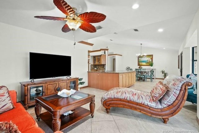 tiled living room featuring ceiling fan with notable chandelier and vaulted ceiling