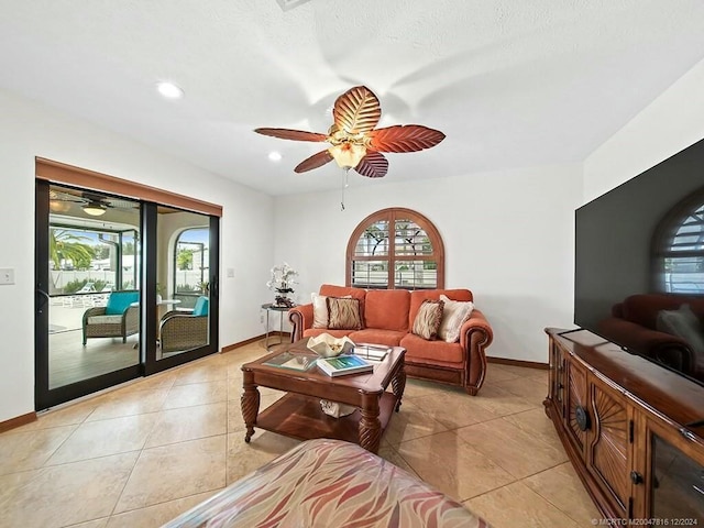 living room featuring light tile patterned floors and ceiling fan