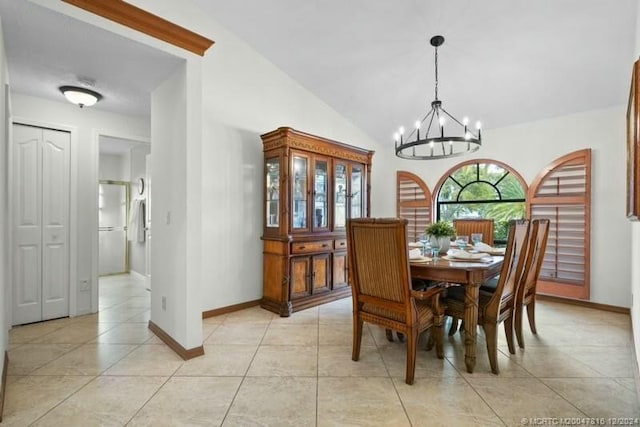 tiled dining area with vaulted ceiling and an inviting chandelier