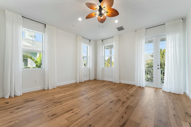 unfurnished room with french doors, light wood-type flooring, and ceiling fan