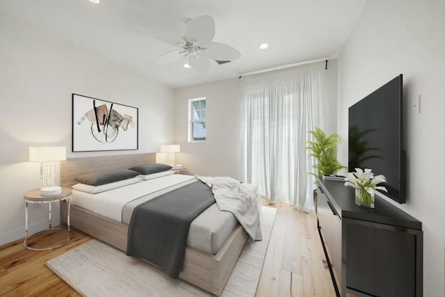 bedroom featuring ceiling fan and light hardwood / wood-style flooring