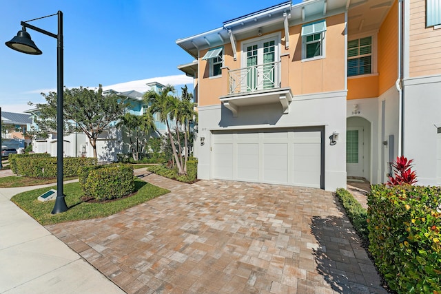 view of front of house with a balcony and a garage