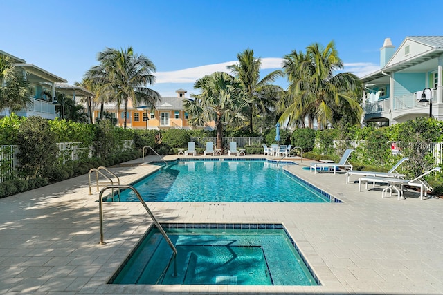 view of pool with a community hot tub and a patio