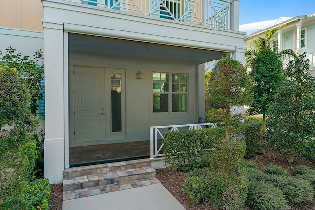 property entrance with a balcony and covered porch