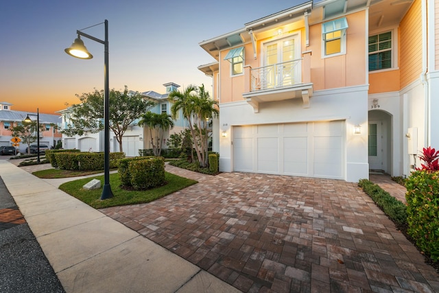 view of front of house with a balcony and a garage