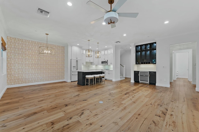 unfurnished living room with light hardwood / wood-style flooring and ceiling fan