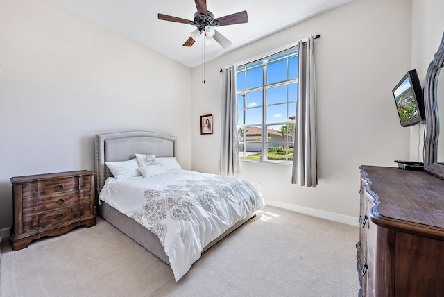 bedroom with ceiling fan, light carpet, and lofted ceiling