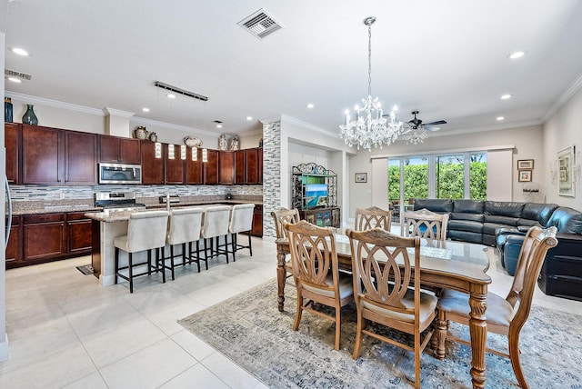 dining room with ceiling fan with notable chandelier, track lighting, crown molding, and light tile patterned flooring