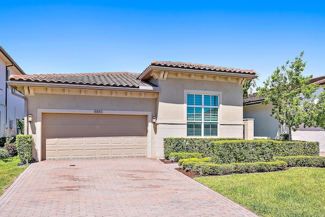 mediterranean / spanish-style house with a garage