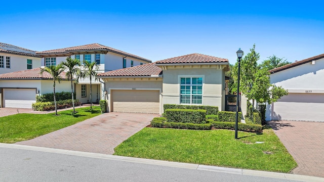 mediterranean / spanish-style home with a front lawn and a garage