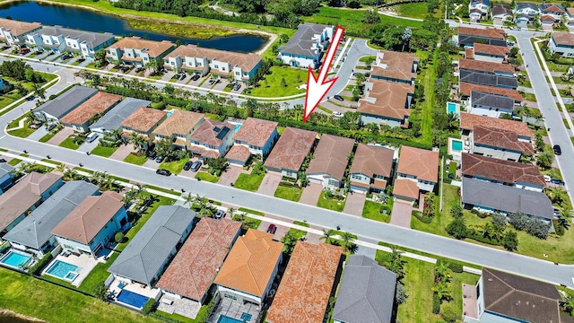 birds eye view of property with a water view