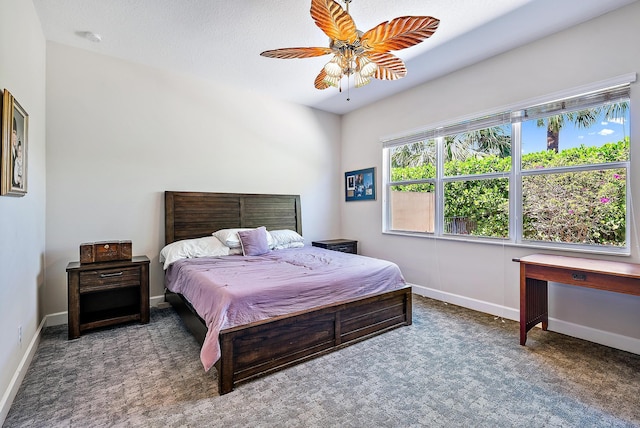 bedroom with dark colored carpet and ceiling fan