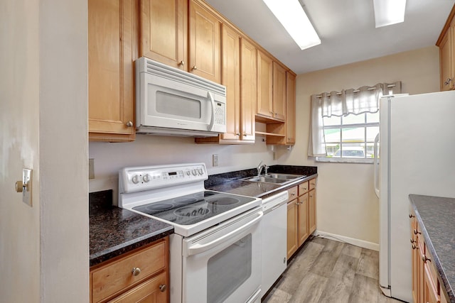 kitchen with sink, white appliances, and light hardwood / wood-style flooring