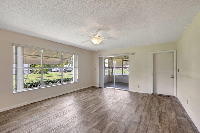 empty room featuring a textured ceiling, hardwood / wood-style flooring, and ceiling fan