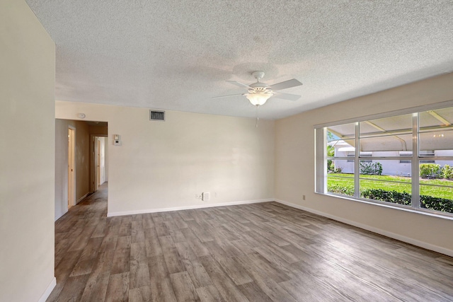 spare room featuring ceiling fan, a textured ceiling, and hardwood / wood-style flooring