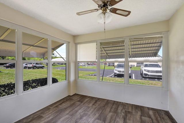 unfurnished sunroom with ceiling fan