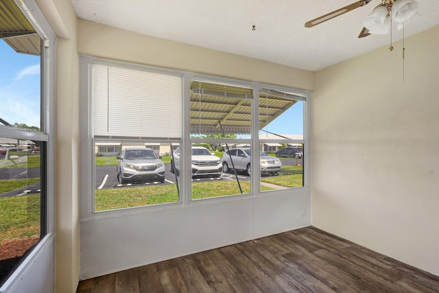 unfurnished sunroom featuring ceiling fan