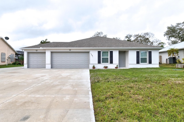 single story home with a front yard and a garage