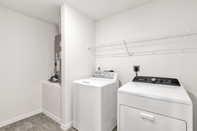 laundry room featuring separate washer and dryer and hardwood / wood-style floors