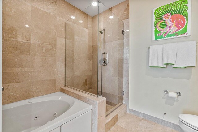 bathroom featuring toilet, tile patterned flooring, and shower with separate bathtub