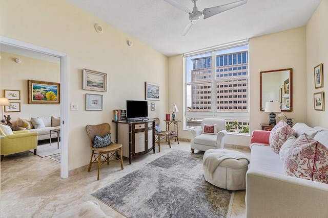 living room with a textured ceiling and ceiling fan