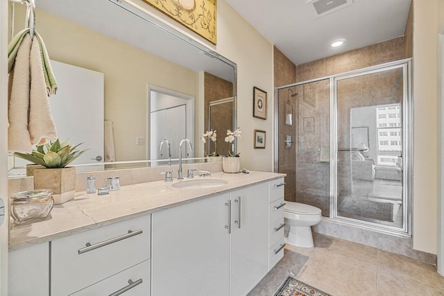 bathroom with a shower with door, vanity, and toilet