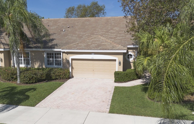 view of front of house featuring a front yard and a garage